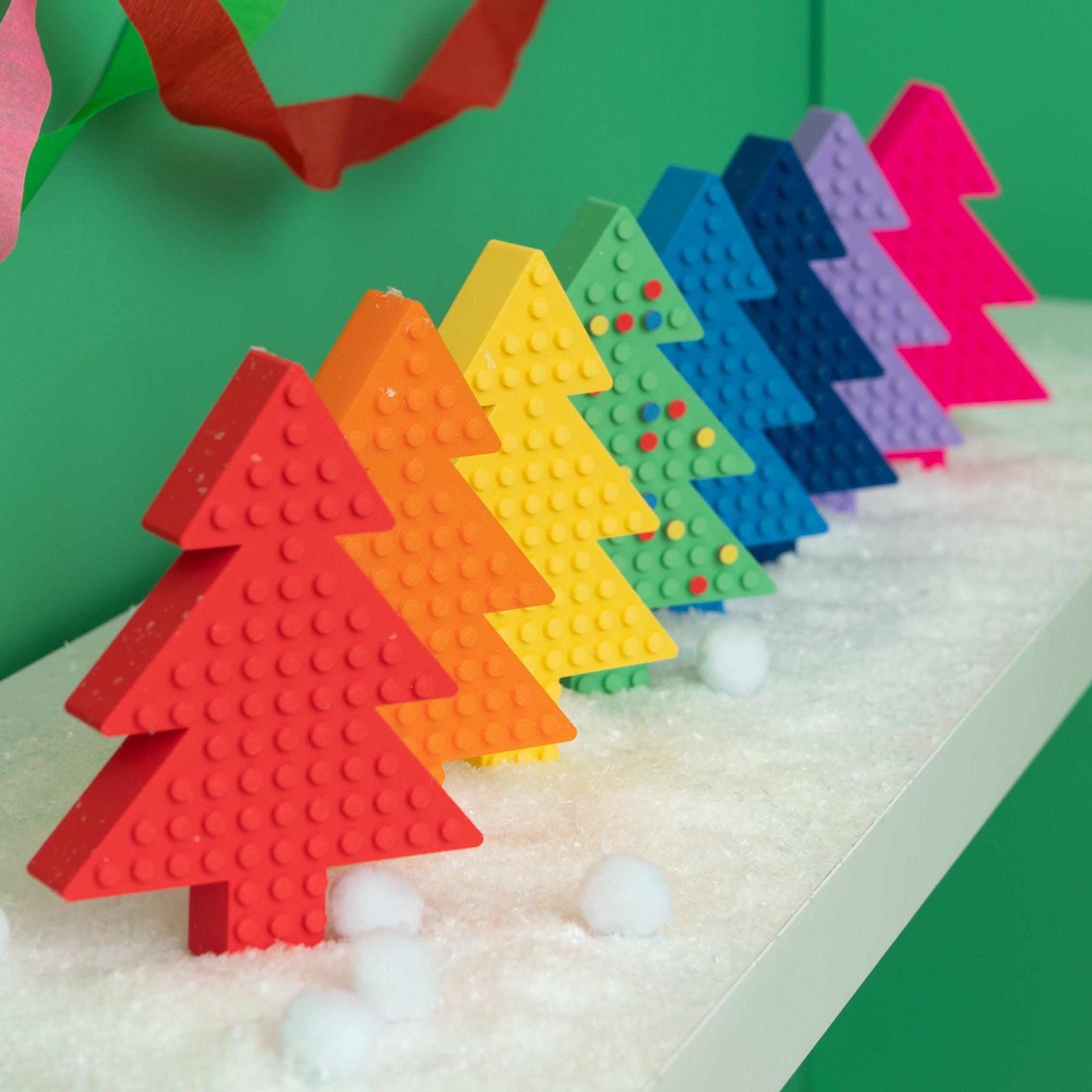 8 Lego Freestanding Christmas Trees, in rainbow order.
