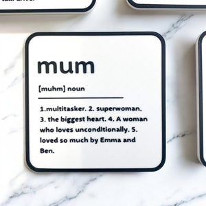 A black and white coaster with personalised name and description on the coaster.