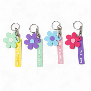 Colourful flower-shaped keychains with personalised name tags.