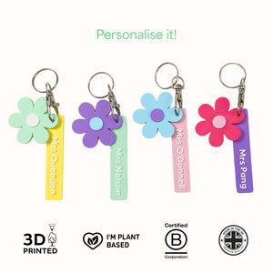 Colourful flower-shaped keychains with personalised name tags.
