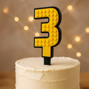 Yellow brick cake number 3 topper with black border on a cake