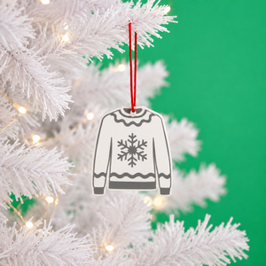 Snowflake Christmas jumper decoration hanging on a white tree