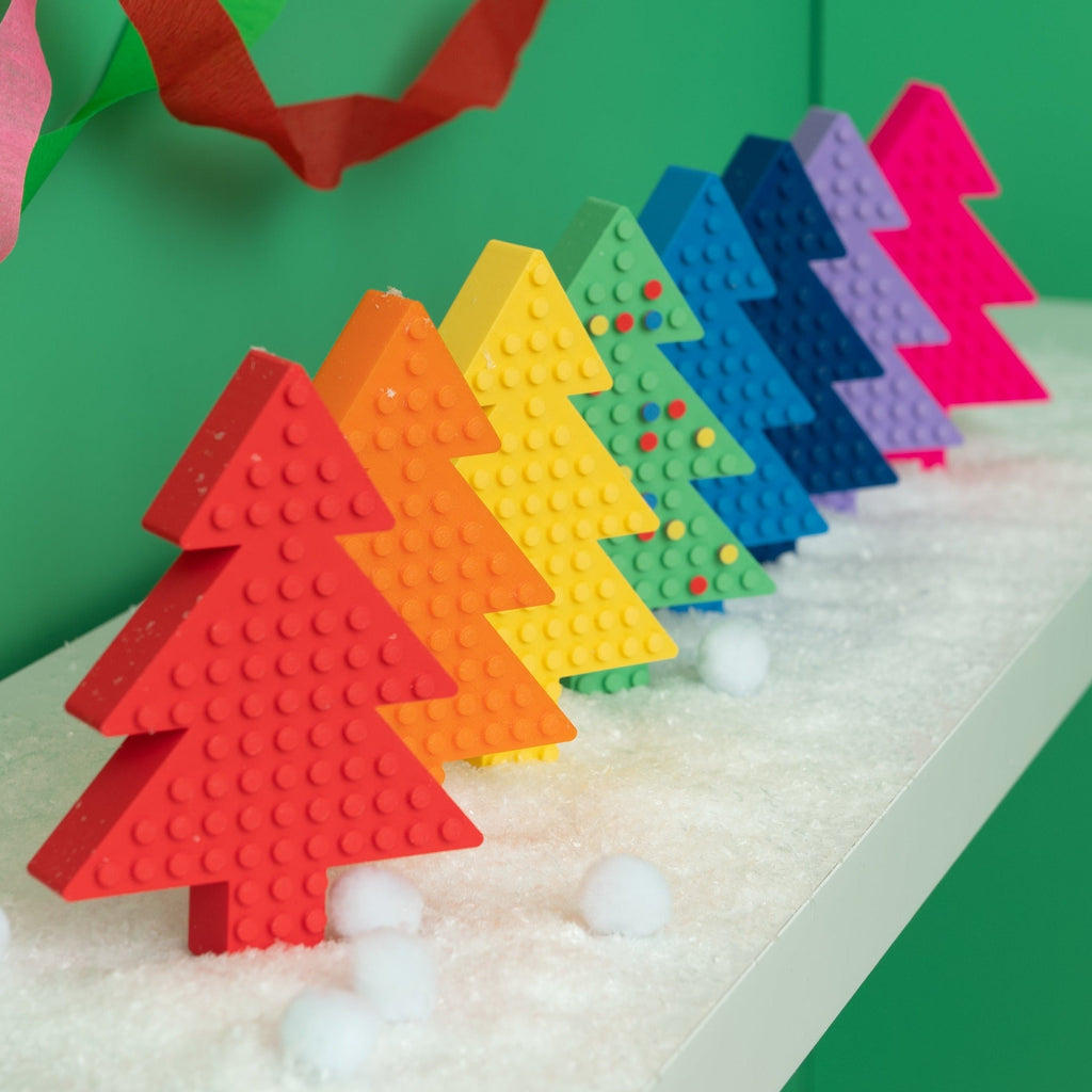 8 Lego Freestanding Christmas Trees, in rainbow order. 