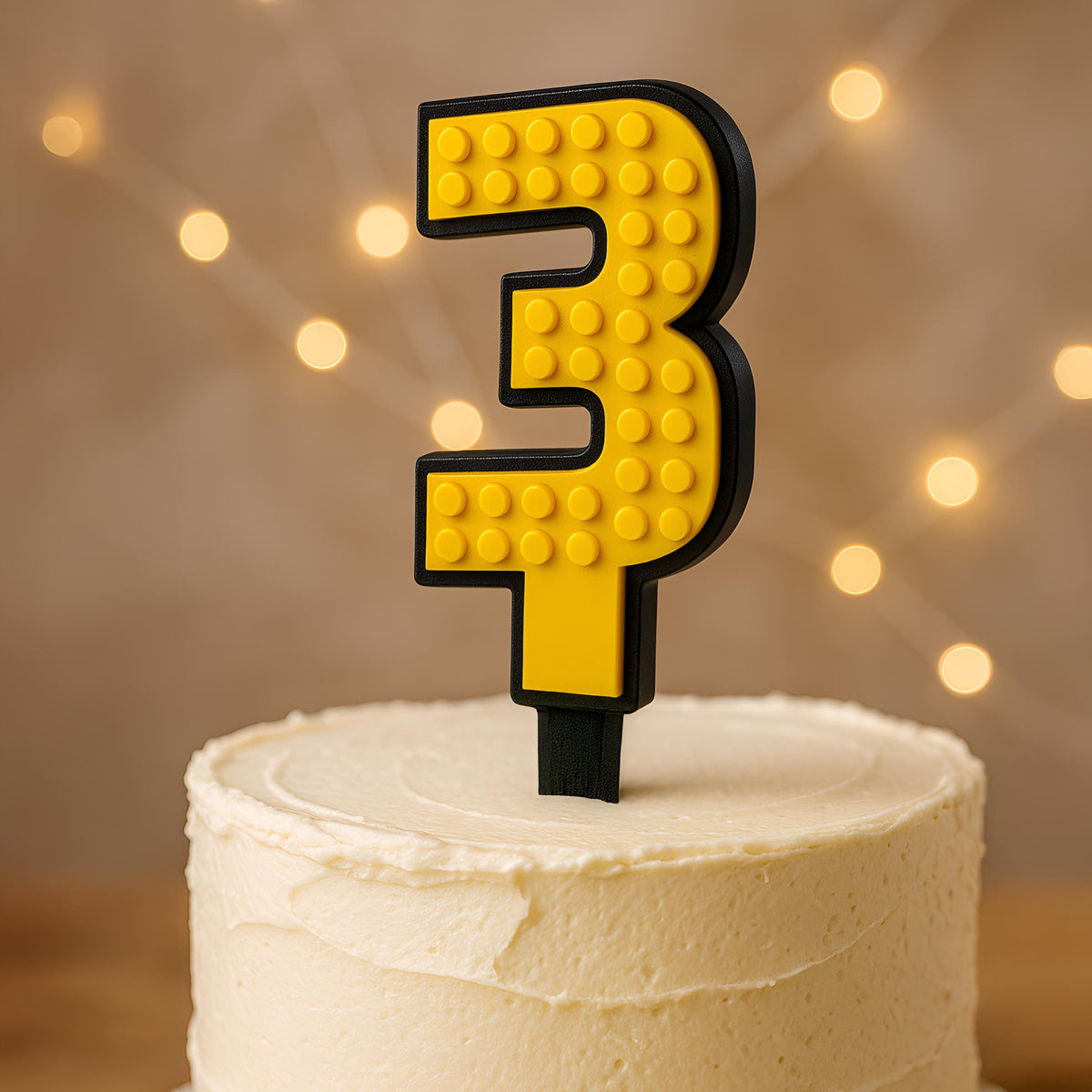 Yellow brick cake number 3 topper with black border on a cake