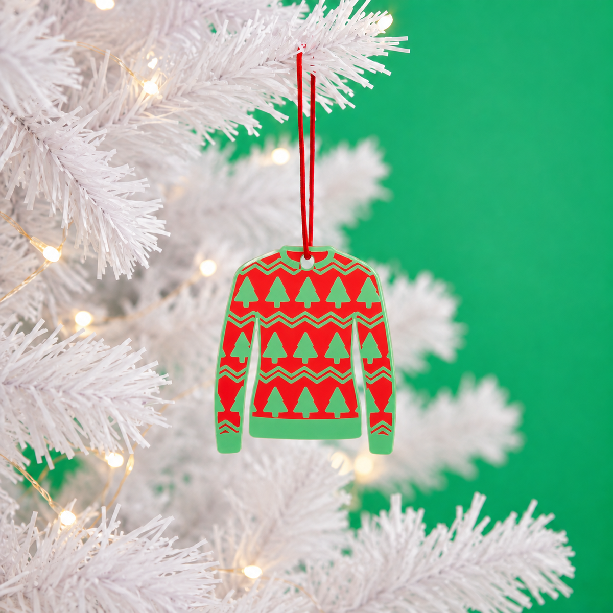 Christmas Trees jumper decoration hanging on a white tree