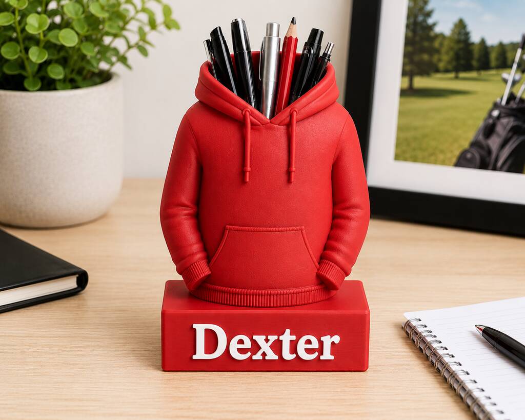 Personalised red hoodie pen pot with the name Dexter on a desk